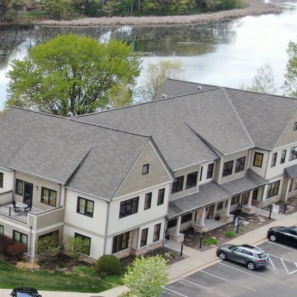 Arial view of commercial building with new ashpalt roof installed by Rooster Exteriors