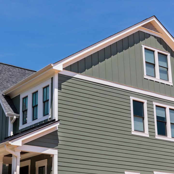Side view of residential home with green vinyl siding